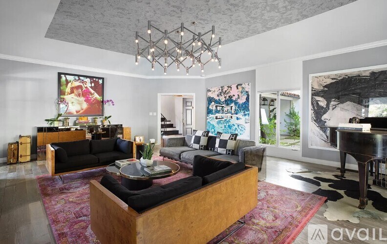 A living room with a black sofa and a wooden coffee table.
