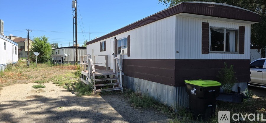 A mobile home with a brown and white exterior is available for rent.