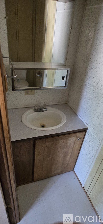 A bathroom with a sink and mirror.