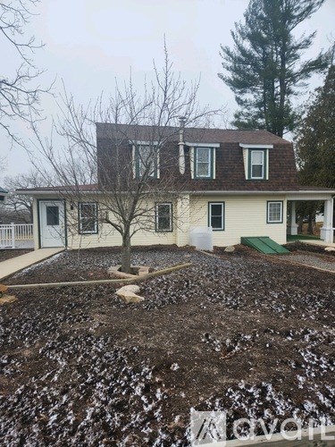 A house with a tree in front of it.