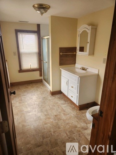 A bathroom with a sink, mirror, and toilet.