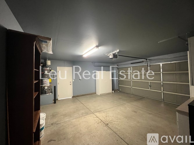 A large empty garage with a sign that says "You are here" and a logo that says "AVAIL".