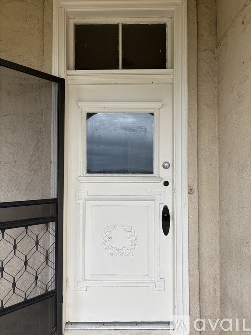 A white door with a glass window and a handle.