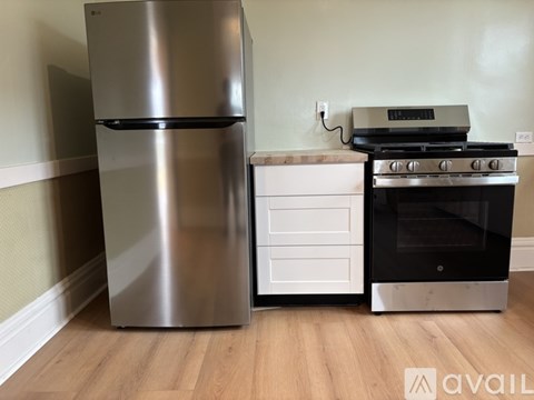 A stainless steel refrigerator and oven in a kitchen.