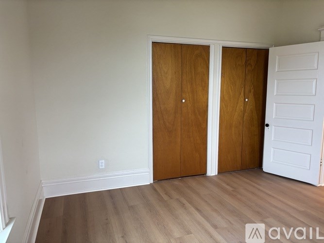 A room with two brown doors and a white door.