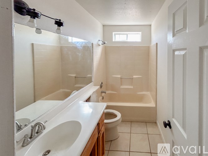 A bathroom with a white sink, toilet, and bathtub.