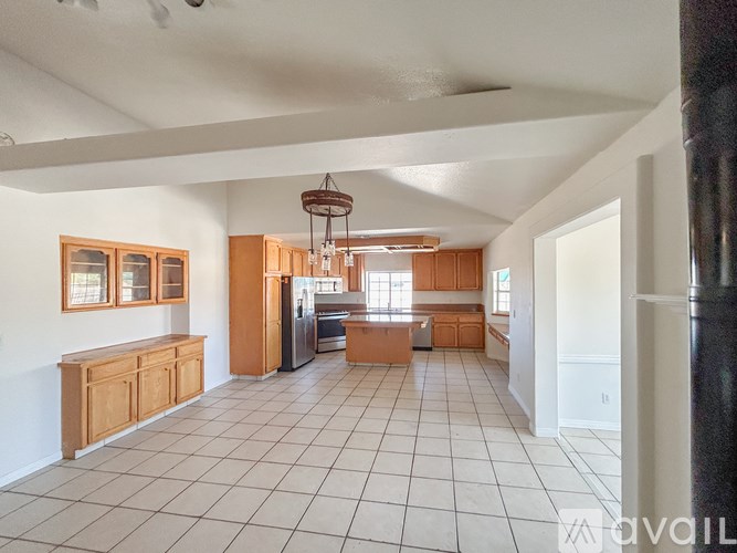 A spacious kitchen with wooden cabinets and a central island.