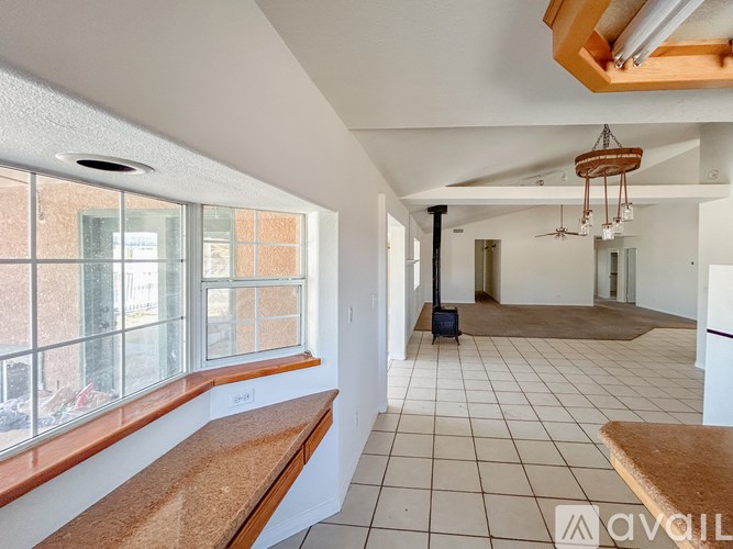A room with a long table and chairs.