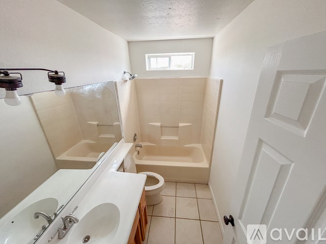 A bathroom with a toilet, sink, and shower.