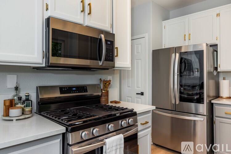 A kitchen with a stainless steel oven and microwave.