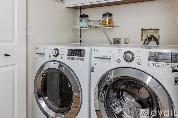 Two front load washing machines in a laundry room.
