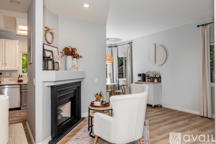 A modern living room with a fireplace and a dining area.