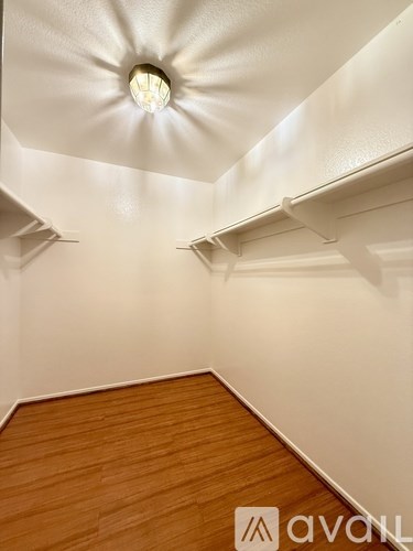 A room with wooden floors and white walls.