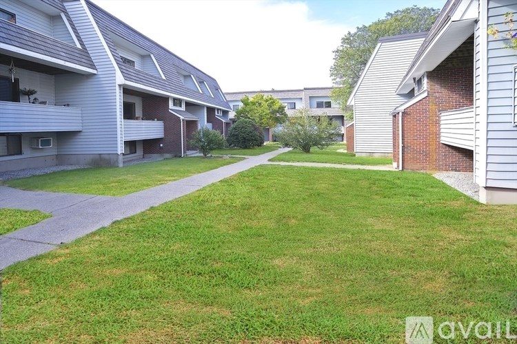 A grassy area in front of apartment buildings.