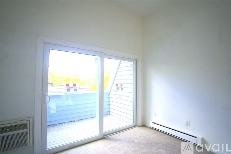 A room with a sliding glass door leading to a backyard.