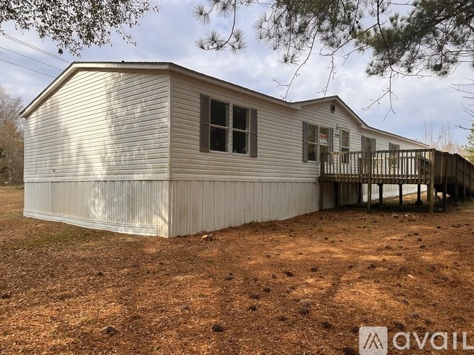 A mobile home with a deck is for sale.