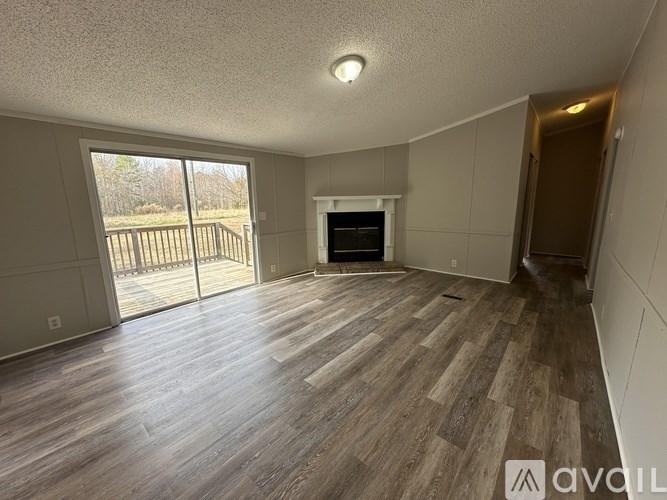A room with wood flooring and a fireplace is available for rent.