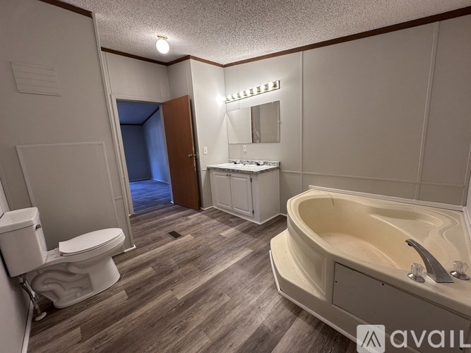 A bathroom with a tub, toilet, and sink.