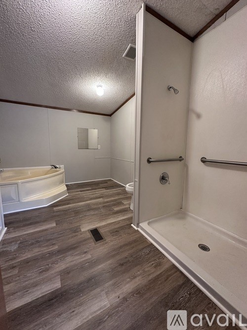 A bathroom with a tub, toilet, and sink.