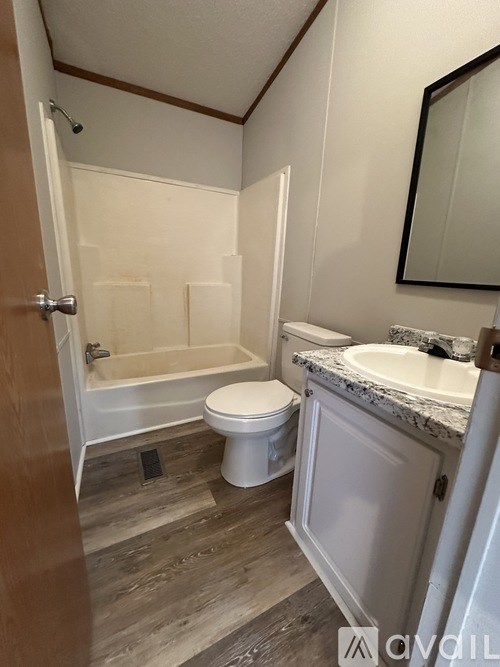 A bathroom with a toilet, sink, and bathtub.