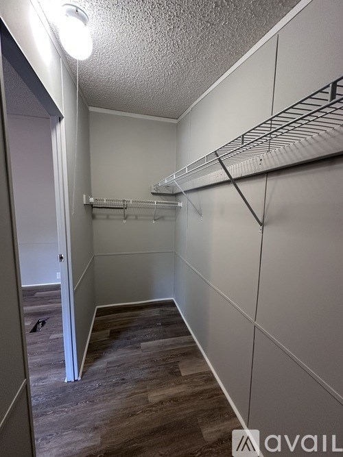 A long hallway with a light on the ceiling and a door on the left.
