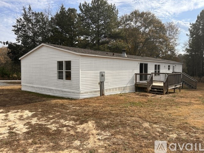 A white house with a porch and a covered entrance.