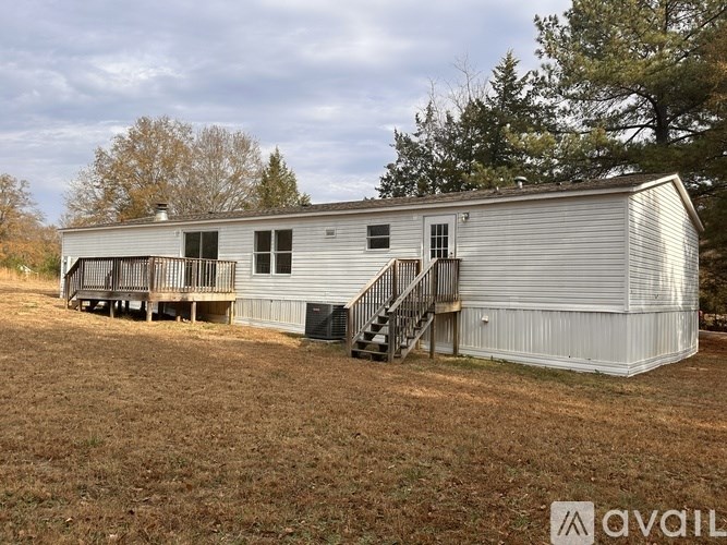 A metal building with a staircase leading to a door.