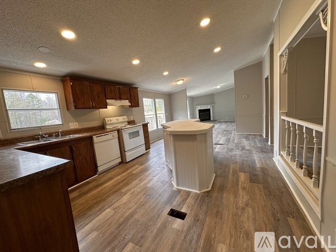 A kitchen with wooden cabinets and a white dishwasher.