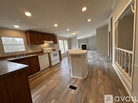 A kitchen with wooden cabinets and a white dishwasher.