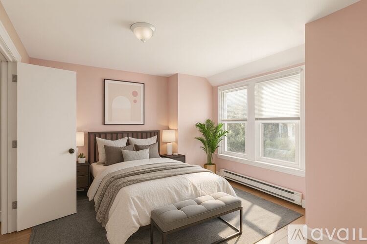 A bedroom with a large bed and a window.