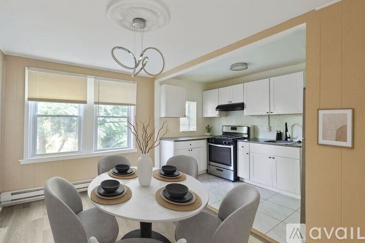A modern kitchen with a dining table set for four.