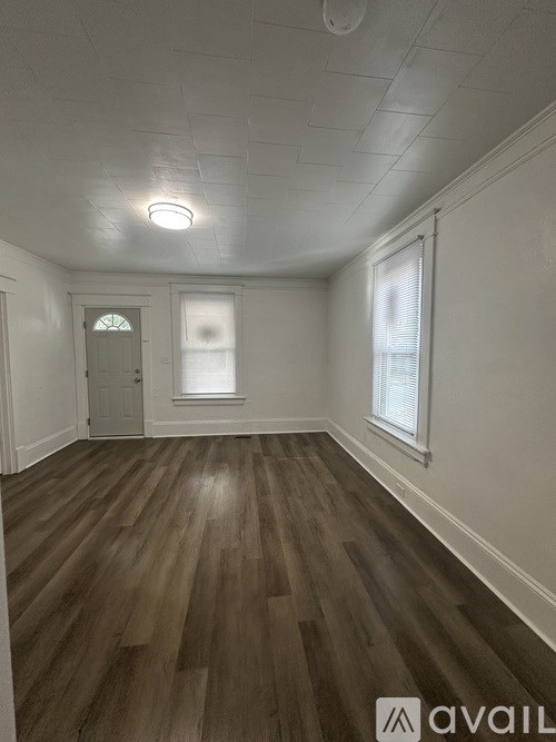 A room with wooden floors and white walls.