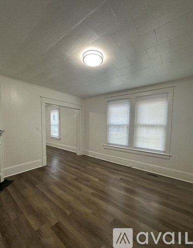 A room with wooden floors and white walls.