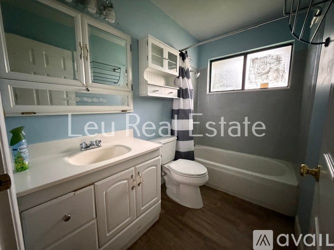 A bathroom with a white sink, toilet, and bathtub.