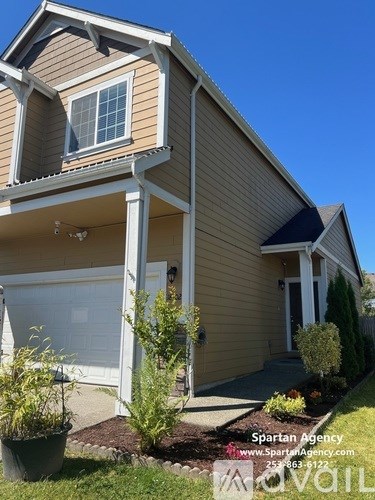 A house with a garage and a window is shown.