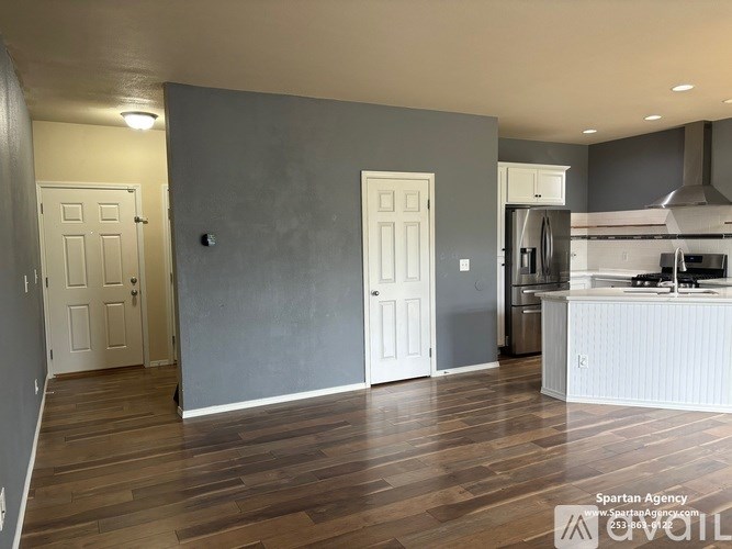 A kitchen with a refrigerator, oven, and sink is shown in this image.