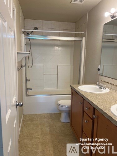 A bathroom with a toilet, sink, and bathtub.