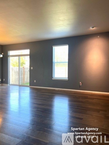 A room with a Spartan Agency logo and contact information on the wall.