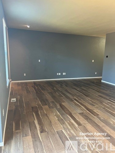 A room with wooden flooring and Spartan Agency branding.