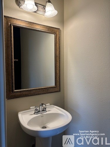 A bathroom with a sink and mirror.