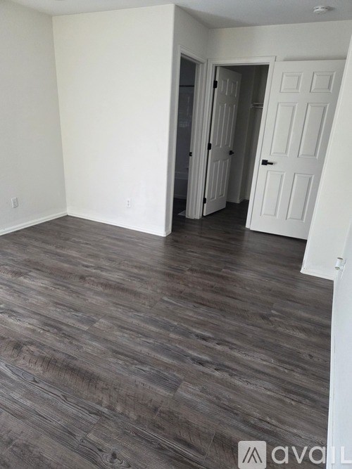 A room with a wooden floor and white walls.