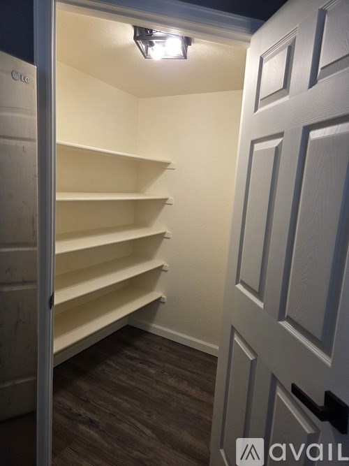 A white door with a handle and a sign that says "available" on the bottom right.