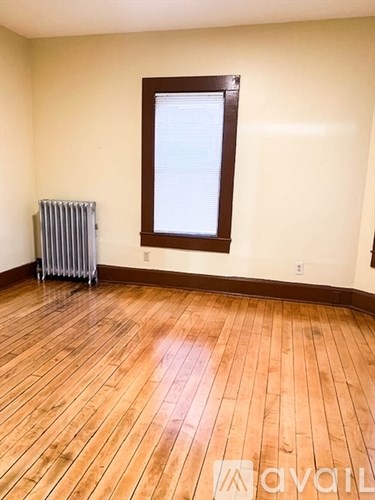 A room with wooden floors and a window.