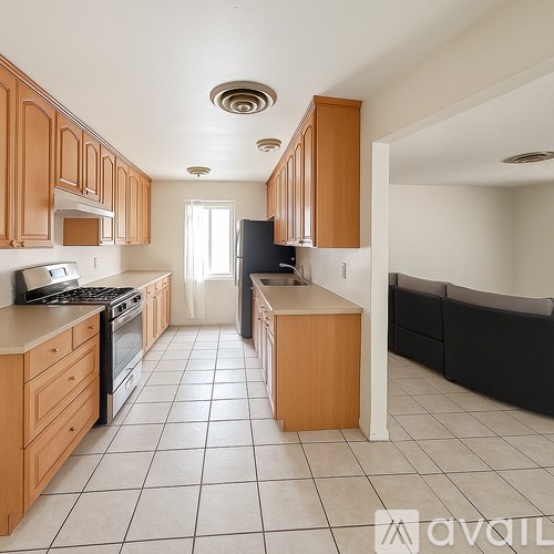 A kitchen with wooden cabinets and black appliances.