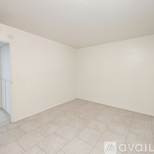 A room with a tiled floor and a door on the left.