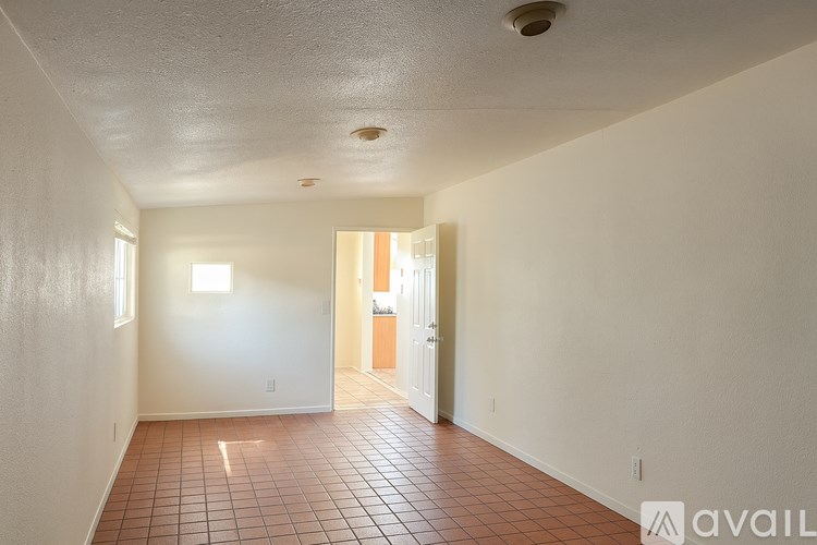A room with tiled flooring and white walls.