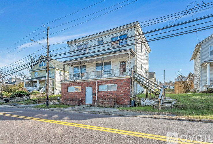 A two-story house with a balcony on the second floor.