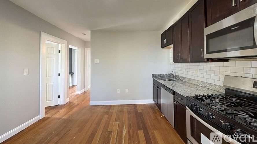 A kitchen with a stove top oven and microwave above it.