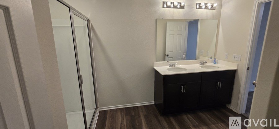 A bathroom with a mirror, sink, and medicine cabinet.