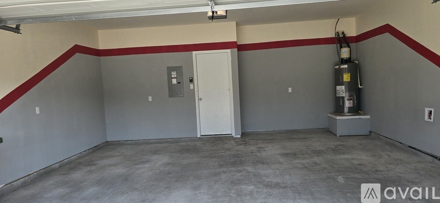 A room with a red stripe on the wall and a door in the middle.